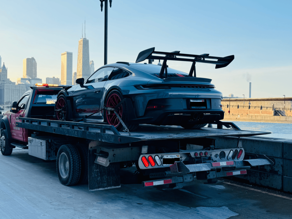 Secure flatbed towing service in Gold Coast, Chicago, providing damage-free transport for cars, trucks, and motorcycles with professional handling and fast response times.
